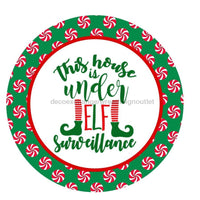 Thumbnail for THIS HOUSE IS UNDER ELF SURVEILLANCE ELF WINTER CHRISTMAS 10.5" Vinyl Wreath Sign - UTIC-VINYL-V989